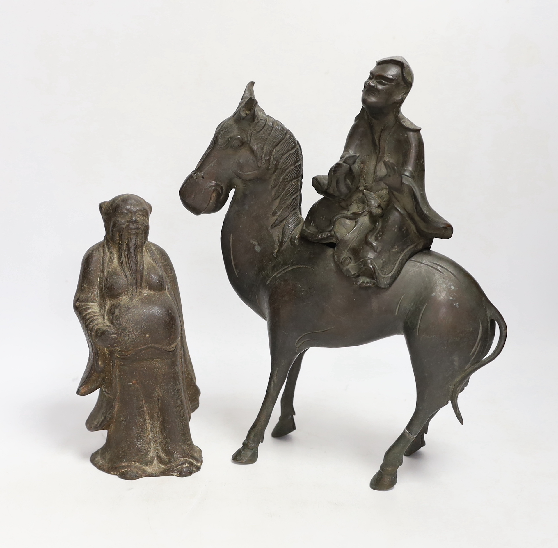 Two Chinese bronze figures; a luohan on his mule and a figure of a wise man, tallest 30cm